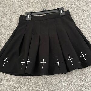 Black pleated mini skirt with white crosses